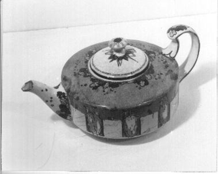 Squat china tea pot decorated with border of owls and mice.