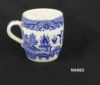 White china mug with handle and willow pattern