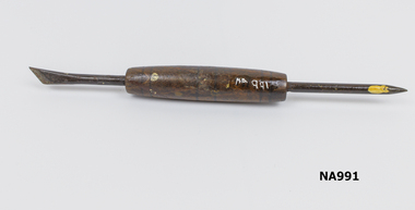 Round wooden centre with metal tools at each end