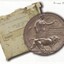 During WW1 a competition took place to design a suitable plaque to be given to the bereaved next of kin of fallen servicemen & women which resulted in the 'Dead Man's Penny'