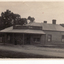 B/W postcard showing first shop in Blackburn, built by Mrs. M. Pearce who sold fruit and vegetables, 