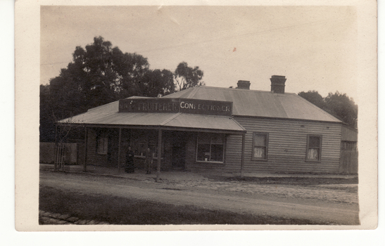 B/W postcard showing first shop in Blackburn, built by Mrs. M. Pearce who sold fruit and vegetables, 