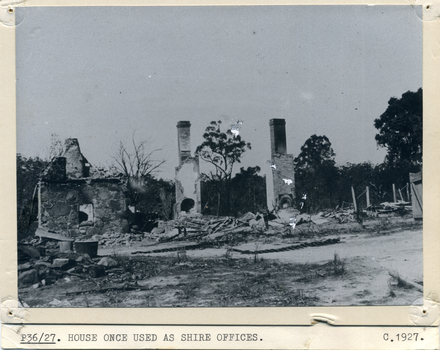 Black and white photo of burnt remains of house used as Shire Offices