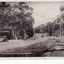 lack and white postcard of Blackburn Road with two cars in photo. 