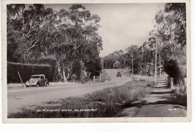 lack and white postcard of Blackburn Road with two cars in photo. 
