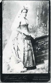 Black and white photo of Marian Hinde, 1886.  The wedding dress in photo on display in museum.