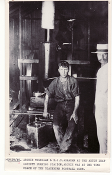 Black and white photo of Archie McLellan in pumping station at Adult Deaf Society with E.T. Abraha