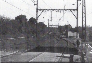 B/W strip photo of Blackburn Road Railway Crossing.