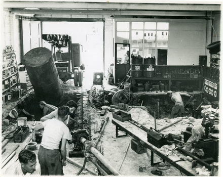 Black and white photo of petrol tanks being installed at garage near South East corner of Station street and Whitehorse road, Mitcham
