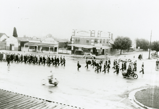 Black and white photo of Anzac Day March C.1950 Whitehorse Road opposite Britannia Street, looking North.