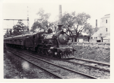 Black and white photo of passenger train, D3 locomotive used  on  the Ringwood line until 1926 passing Blackburn Tile Works