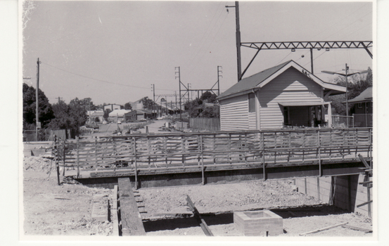 Black and white photo of temporary bridge during alterations at Blackburn Railway Station to accommodate the third rail line from Box Hill  in March 1980