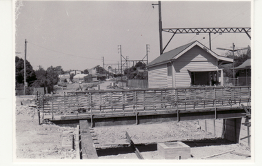 Black and white photo of temporary bridge during alterations at Blackburn Railway Station to accommodate the third rail line from Box Hill  in March 1980