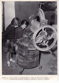Schwerkolt  Cottage showing children looking at a washer/wringer.