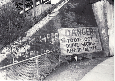Black and white photo 'Toot - Toot' sign at Laburnum Railway bridge. 