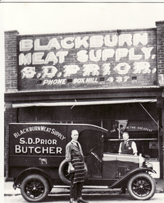 Black and white photo of Dudley & Leo Prior inspecting their new delivery van outside their business Blackburn Meat Supply in 1927.
