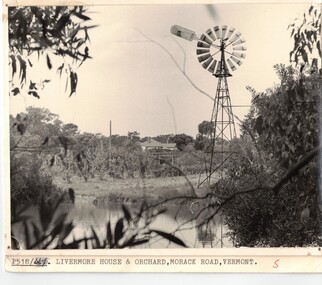 Black & white photo of dam and windmill 