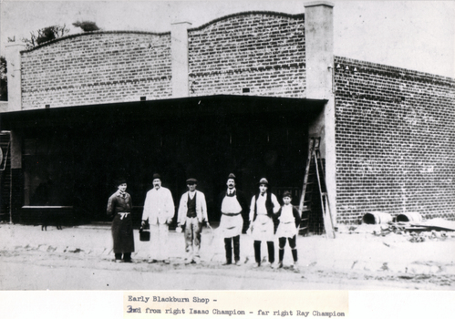 Black & white photo of early Blackburn shop under construction.