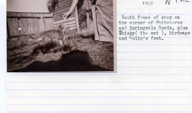 Photograph, Fence surrounding shop owned by Fraser Family, 1948