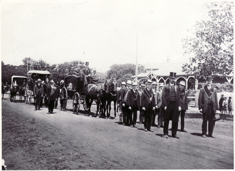Black and white photo of John McGlone's Funeral on 3 September 1892.. Horse drawn hearse with pallbearers 