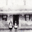 Sepia photo of Amy Cook and Grace Clements
taken outside a house in Mitcham.  Circa 1889-90.