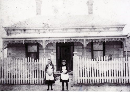 Sepia photo of Amy Cook and Grace Clements
taken outside a house in Mitcham.  Circa 1889-90.