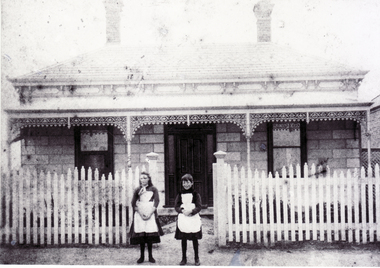 Sepia photo of Amy Cook and Grace Clements
taken outside a house in Mitcham.  Circa 1889-90.