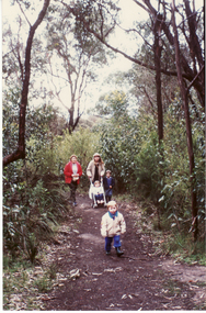 Coloured photo of people walking around Blackburn Lake.