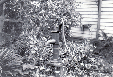 Black and white photo of Water Pump outside Blackburn Hall