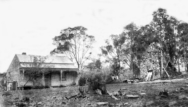 Schwerkolt Property 3rd house -weatherboard house with verandah on the left of the photo and the stone smokehouse on the right.