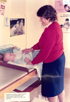 Coloured photo of Mother and Baby at Infant Welfare Centre.