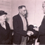 Photo of Presentation of a silver medal by Mr. Don Walker to Mr. Harry Alderton for 50 years service to Australian Tesselated Tile Company.   Mrs Alderton is also in the picture.