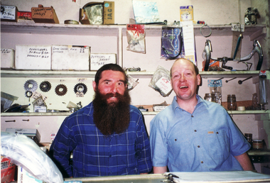 Noel Shone (full time assistant) and part time assistant behind counter in shop.