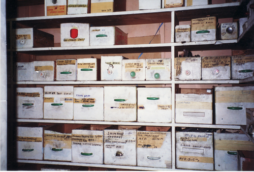 storage boxes containing bicycle parts in shop.