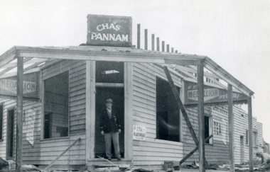 Chas. Pannam standing in doorway of his General Strore which stood on corner of Boronia and Canterbury Roads, Vermont.