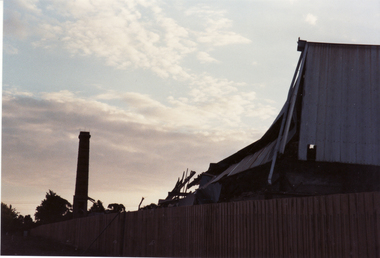 Physical description  Vitclay Chimney, prior to demolition in 1995, with demolished shed in foreground. 