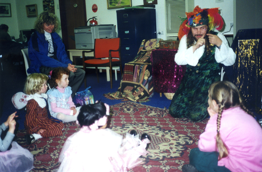 Jason the Faery Tale Man telling stories to the children on a very wet Wisteria Party Day