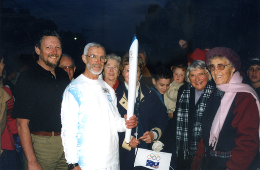 Society members and ex Olympian, Bob Gardiner, carrying the Olympic Flame along Springvale Road between Burwood Highway and High Street Road