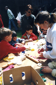 Children at 'Playdo' table in the Schwerkolt Cottage garden at the Wisteria Garden Party 2000.