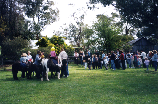 Children queuing for pony rides at Wisteria Garden Party 2000.