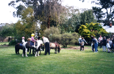 Children on pony rides at Wisteria Garden Party 2000.