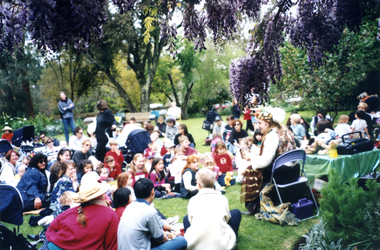 Jason, the Teddy Tale Man entertaining children in garden of Schwerkolt Cottage at Wisteria Garden Party 2000.