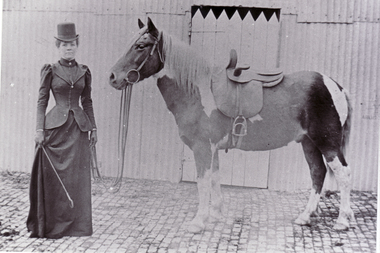 Tess McLelland dressed in riding habit with her horse.