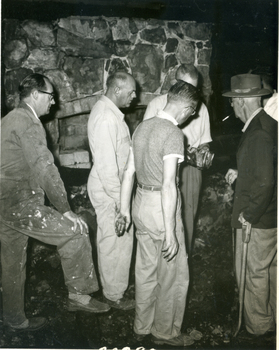 Toc H Members inspecting fire damage to log cabin off Agra Street Mitcham - March 1960