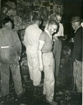 Toc H Members inspecting fire damage to log cabin off Agra Street, Mitcham - March 1960.