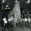 Toc H members of Mitcham Branch outside burnt remains of log cabin off Agra Street, Mitcham in March 1960