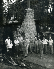 Toc H members of Mitcham Branch outside burnt remains of log cabin off Agra Street, Mitcham in March 1960