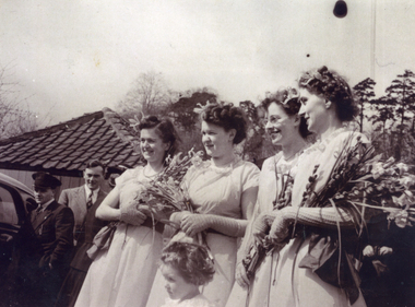 Joyce Suto in bridesmaids dress of gold nylon with olive green sash, worn at wedding in Gloucestshire, England on 8th April 1947. 