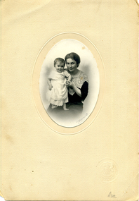 In the middle of a cream background, Mary Matheson and her daughter, Marjorie as a baby.