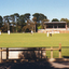 Walker Park, Whitehorse Road, Mitcham showing Cricket match in progress with the grandstand in background. 